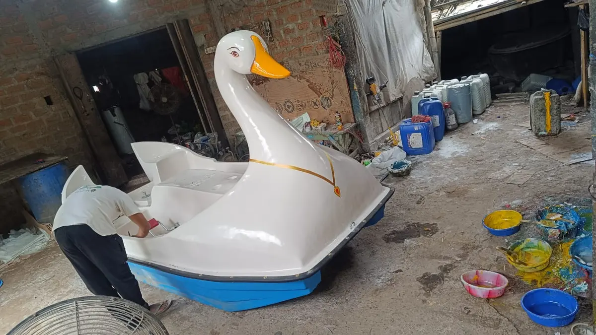White swan pedal boat being finished in the workshop