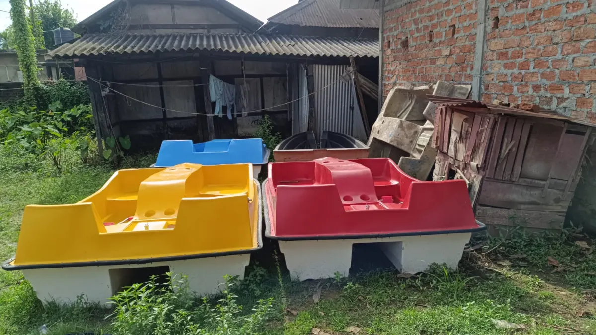 Yellow and red family pedal boats on twin white hulls, with a blue one behind