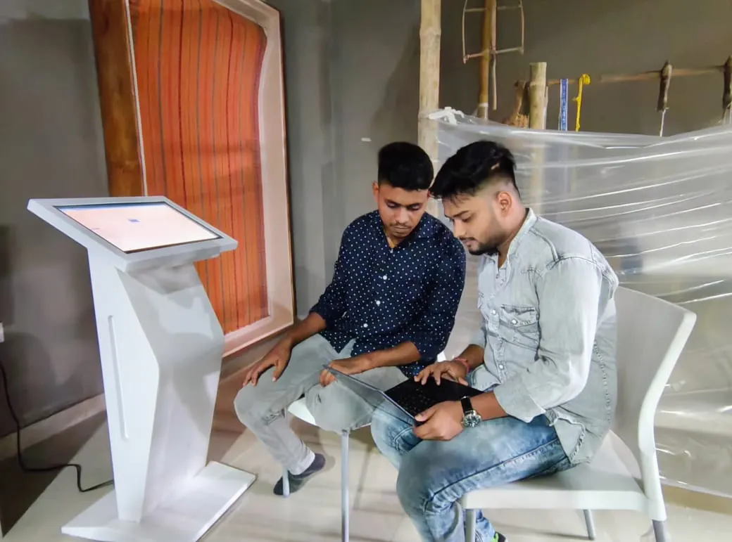 Boat Brothers engineers setting up a kiosk at Sri Sri Madhabdev Kalakshetra